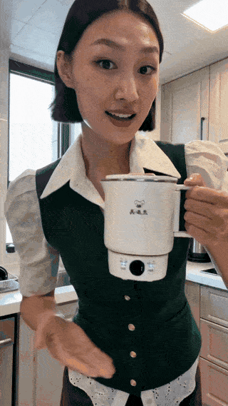 Kettle boiling water with steam rising, on a kitchen counter